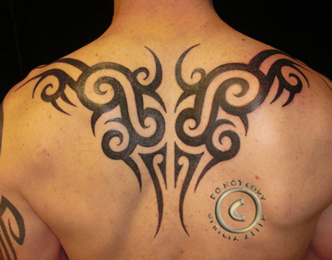 Brad wears a back tattoo in a tribal style reminiscent of Indonesian design.